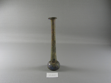 Roman. <em>Long-necked Toilet Bottle of Plain Blown Glass</em>, 1st-5th century C.E. Glass, 7 5/16 x Diam. 1 13/16 in. (18.5 x 4.6 cm). Brooklyn Museum, Gift of Robert B. Woodward, 01.205. Creative Commons-BY (Photo: Brooklyn Museum, CUR.01.205_view1.jpg)