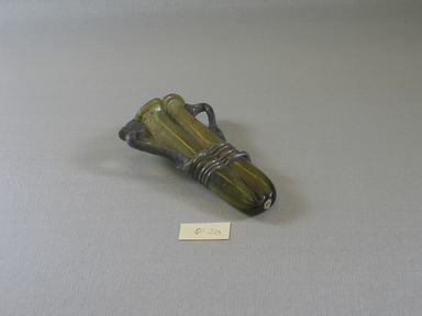 Roman. <em>Double Cosmetic Tube with Handles</em>, 4th-5th century C.E. Glass, 2 3/4 x 1 3/8 x 4 1/2 in. (7 x 3.5 x 11.5 cm). Brooklyn Museum, Gift of Robert B. Woodward, 01.210. Creative Commons-BY (Photo: Brooklyn Museum, CUR.01.210_view1.jpg)
