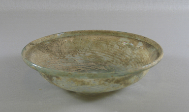 Roman. <em>Shallow Bowl of Molded Glass</em>, 1st-5th century C.E. Glass, 1 11/16 x Diam. 6 11/16 in. (4.3 x 17 cm). Brooklyn Museum, Gift of Robert B. Woodward, 01.246. Creative Commons-BY (Photo: Brooklyn Museum, CUR.01.246_view1.jpg)