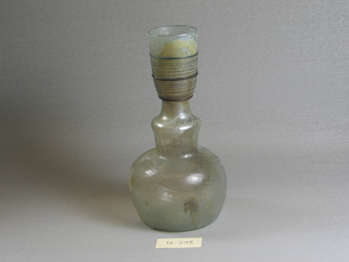 Roman. <em>Bottle of Plain Blown Glass</em>, 4th-5th century C.E. Glass, 6 11/16 x Diam. 3 3/8 in. (17 x 8.5 cm). Brooklyn Museum, Gift of Robert B. Woodward, 01.248. Creative Commons-BY (Photo: Brooklyn Museum, CUR.01.248.jpg)