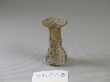 Roman. <em>Bottle of Blown Glass</em>, 1st-12nd century C.E. Glass, 1 13/16 x greatest diam. 1 in. (4.6 x 2.6 cm). Brooklyn Museum, Gift of Robert B. Woodward, 01.288. Creative Commons-BY (Photo: Brooklyn Museum, CUR.01.288_view1.jpg)