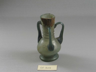 Roman. <em>Vase of Molded Glass</em>, 1st-5th century C.E. Glass, 3 11/16 x 2 1/8 x 2 1/2 in. (9.3 x 5.4 x 6.3 cm). Brooklyn Museum, Gift of Robert B. Woodward, 01.304. Creative Commons-BY (Photo: Brooklyn Museum, CUR.01.304_view2.jpg)