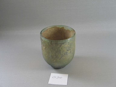 Roman. <em>Goblet of Blown Green Glass</em>, 1st-4th century C.E. Glass, 3 9/16 x greatest diam. 3 1/16 in. (9 x 7.8 cm). Brooklyn Museum, Gift of Robert B. Woodward, 01.310. Creative Commons-BY (Photo: Brooklyn Museum, CUR.01.310.jpg)