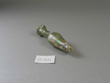 Roman. <em>Bottle of Plain Blown Glass</em>, 1st-12th century C.E. Glass, 3 3/4 x greatest diam. 1 in. (9.6 x 2.5 cm). Brooklyn Museum, Gift of Robert B. Woodward, 01.321. Creative Commons-BY (Photo: Brooklyn Museum, CUR.01.321_view2.jpg)