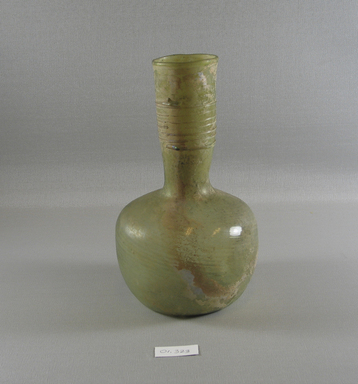 Roman. <em>Decanter-like Vase of Blown Glass</em>, 3rd-5th century C.E. Glass, 7 15/16 x greatest diam. 4 3/4 in. (20.2 x 12 cm). Brooklyn Museum, Gift of Robert B. Woodward, 01.323. Creative Commons-BY (Photo: Brooklyn Museum, CUR.01.323_view1.jpg)