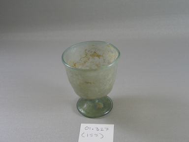 Roman. <em>Small Goblet of Plain Blown Light Blue-green Glass</em>, 5th-early 7th century C.E. Glass, 3 1/16 x greatest diam. 2 11/16 in. (7.7 x 6.8 cm) . Brooklyn Museum, Gift of Robert B. Woodward, 01.327. Creative Commons-BY (Photo: Brooklyn Museum, CUR.01.327.jpg)