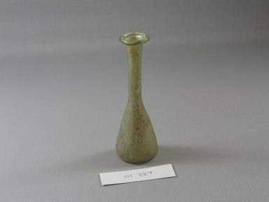 Roman. <em>Small Perfume Bottle</em>, 1st-5th century C.E. Glass, Greatest diam. 1 5/8 x 4 1/8 in. (4.2 x 10.5 cm). Brooklyn Museum, Gift of Robert B. Woodward, 01.337. Creative Commons-BY (Photo: Brooklyn Museum, CUR.01.337_view1.jpg)