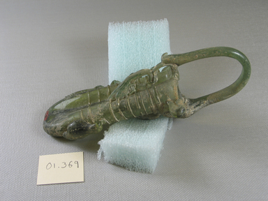 Roman. <em>Double Cosmetic Tube with Basket Handle</em>, 4th-6th century C.E. Glass, 6 9/16 x greatest width  2 7/16 in. (16.7 x 6.2 cm). Brooklyn Museum, Gift of Robert B. Woodward, 01.369. Creative Commons-BY (Photo: Brooklyn Museum, CUR.01.369_view1.jpg)