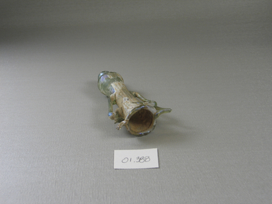 Roman. <em>Cosmetic Tube with Handles</em>, 6th-7th century C.E. Glass, 4 1/8 x 2 1/16 in. (10.5 x 5.2 cm). Brooklyn Museum, Gift of Robert B. Woodward, 01.388. Creative Commons-BY (Photo: Brooklyn Museum, CUR.01.388_view1.jpg)
