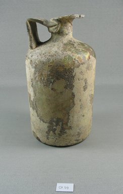 Roman. <em>Bottle of Plain Blown Glass</em>, 1st-4th century C.E. Glass, 7 1/16 x greatest diam. 3 3/4 in. (18 x 9.5 cm). Brooklyn Museum, Gift of Robert B. Woodward, 01.396. Creative Commons-BY (Photo: Brooklyn Museum, CUR.01.39_view1.jpg)