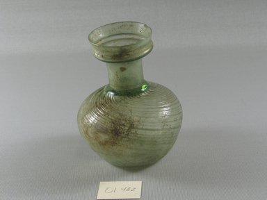 Roman. <em>Bottle of Blown Green Glass</em>, 1st-5th century C.E. Glass, 4 5/16 x Diam. 3 3/8 in. (10.9 x 8.6 cm). Brooklyn Museum, Gift of Robert B. Woodward, 01.432. Creative Commons-BY (Photo: Brooklyn Museum, CUR.01.432_view2.jpg)