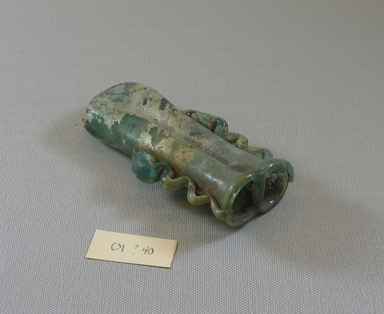 Roman. <em>Double Cosmetic Tube with Ribbon Handles</em>, 4th-6th century C.E. Glass, 4 3/4 x 2 5/16 x 1 1/8 in. (12 x 5.8 x 2.9 cm). Brooklyn Museum, Gift of Robert B. Woodward, 01.440. Creative Commons-BY (Photo: Brooklyn Museum, CUR.01.440_view1.jpg)