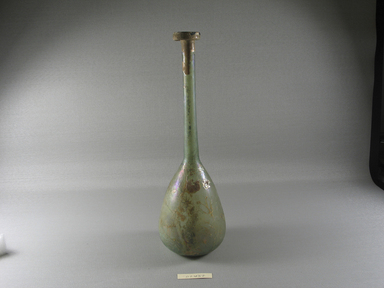 Roman. <em>Bottle of Plain Blown Glass</em>, 1st-3rd century C.E. Glass, 10 11/16 x Diam. 3 3/8 in. (27.2 x 8.5 cm). Brooklyn Museum, Gift of Robert B. Woodward, 01.457. Creative Commons-BY (Photo: Brooklyn Museum, CUR.01.457_view1.jpg)