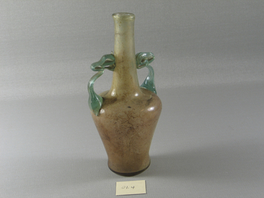 Roman. <em>Flask with Elaborate Handles</em>, 4th-early 5th century C.E. Glass, 6 9/16 x 3 1/16 in. (16.6 x 7.7 cm). Brooklyn Museum, Gift of Robert B. Woodward, 01.4. Creative Commons-BY (Photo: Brooklyn Museum, CUR.01.4_view1.jpg)
