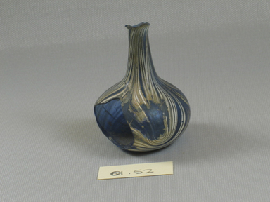 Roman. <em>Bottle of Blown Glass</em>, 3rd-4th century C.E. Glass, 2 5/8 x Diam. 2 in. (6.6 x 5.1 cm). Brooklyn Museum, Gift of Robert B. Woodward, 01.52. Creative Commons-BY (Photo: Brooklyn Museum, CUR.01.52_view1.jpg)