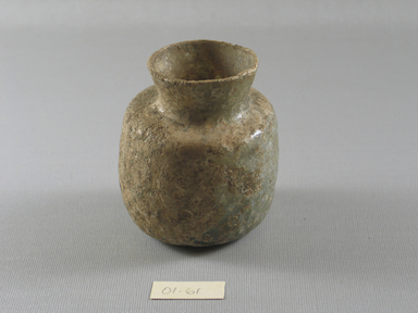 Islamic. <em>Vase of Molded Glass</em>, 8th-11th century C.E. Glass, 3 1/4 x 2 3/4 in. (8.2 x 7 cm). Brooklyn Museum, Gift of Robert B. Woodward, 01.61. Creative Commons-BY (Photo: Brooklyn Museum, CUR.01.61_view1.jpg)