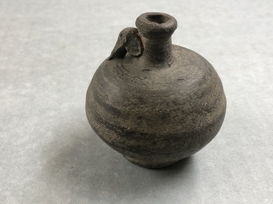  <em>Jar</em>. Clay, slip, 2 7/16 × Diam. 2 5/16 in. (6.2 × 5.8 cm). Brooklyn Museum, Gift of the Egypt Exploration Society, 02.219. Creative Commons-BY (Photo: , CUR.02.219_view01.jpg)