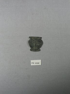  <em>Head of Hathor</em>, ca. 1539-1292 B.C.E. Sheet copper?, 1 x 1 in. (2.6 x 2.5 cm). Brooklyn Museum, Gift of the Egypt Exploration Fund, 02.225. Creative Commons-BY (Photo: Brooklyn Museum, CUR.02.225_view1.jpg)