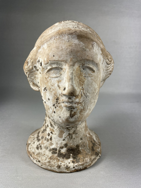 Greek. <em>Vase in Shape of Woman's Head</em>, late 2nd century B.C.E. (probably). Clay, slip, 6 1/2 × 4 1/16 × 4 1/16 in. (16.5 × 10.3 × 10.3 cm). Brooklyn Museum, Gift of Robert B. Woodward, 03.286. Creative Commons-BY (Photo: Brooklyn Museum, CUR.03.286_view01.jpeg)