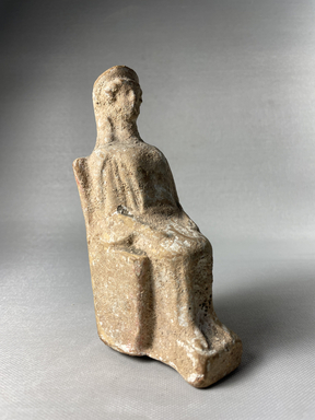 Possibly Greek. <em>Votive Statuette, Hollow, of a Female Seated on a Square Chair in Stiff Early Attitude</em>, 6th century B.C.E. Terracotta, pigment, 5 11/16 × 2 1/2 × 2 3/4 in. (14.5 × 6.3 × 7 cm). Brooklyn Museum, Purchase gift of Robert B. Woodward and Carll H. de Silver, 04.20. Creative Commons-BY (Photo: Brooklyn Museum, CUR.04.20_view01.jpeg)