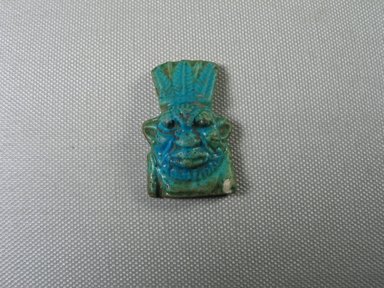  <em>Bes Amulet</em>, 7th century B.C.E. Faience, 1 3/4 × 1 1/16 × 3/8 in. (4.4 × 2.7 × 1 cm). Brooklyn Museum, Charles Edwin Wilbour Fund, 05.361. Creative Commons-BY (Photo: , CUR.05.361_view01.jpg)
