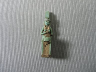  <em>Amulet of Seated Isis Holding Horus</em>. Faience, 2 3/8 × 9/16 × 7/8 in. (6 × 1.5 × 2.2 cm). Brooklyn Museum, Charles Edwin Wilbour Fund, 05.373. Creative Commons-BY (Photo: , CUR.05.373_view01.jpg)