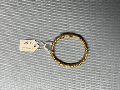  <em>Bracelet Composed of Two Heavy Undecorated Bands Braided to Form a Loop</em>, 2nd century C.E. Gold, 1 5/8 x (Diam.) 1 7/8 in. (4.2 x 4.7 cm). Brooklyn Museum, Charles Edwin Wilbour Fund, 05.388. Creative Commons-BY (Photo: Brooklyn Museum, CUR.05.388_overall01.JPG)