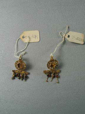 Roman. <em>Pair of Earrings</em>, 3rd century C.E. Gold, glass, garnet, 9/16 x 1 15/16 in. (1.4 x 5 cm). Brooklyn Museum, Ella C. Woodward Memorial Fund, 05.427.1-.2. Creative Commons-BY (Photo: Brooklyn Museum, CUR.05.427.1-.2_overall.jpg)