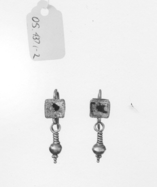 Roman. <em>Pair of Earrings</em>, 2nd century C.E. Gold, glass, Length: 1 1/8 in. (2.9 cm). Brooklyn Museum, Ella C. Woodward Memorial Fund, 05.437a-b. Creative Commons-BY (Photo: Brooklyn Museum, CUR.05.437a-b_NegGRPB_print_bw.jpg)