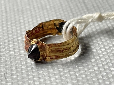 Roman. <em>Small Finger Ring</em>, 2nd-3rd century C.E. Gold, garnet, 3/16 x 7/16 in. (0.4 x 1.1 cm). Brooklyn Museum, Ella C. Woodward Memorial Fund, 05.520. Creative Commons-BY (Photo: Brooklyn Museum, CUR.05.520_overall01.JPG)