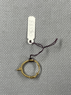 Roman. <em>Earring</em>, 1st-3rd century C.E. Gold, 13/16 in. (2.1 cm). Brooklyn Museum, Ella C. Woodward Memorial Fund, 05.533. Creative Commons-BY (Photo: Brooklyn Museum, CUR.05.533_overall.JPG)