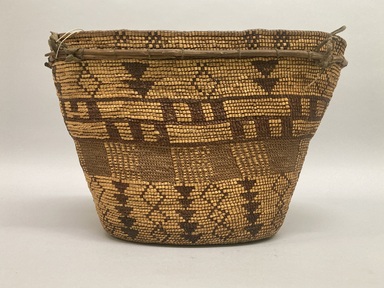 Tsilhqot'in. <em>Coiled Burden Basket</em>, 1901-1933. Wood, spruce root, grass stems (Phragmites sp.), hide, cedar root, 9 5/8 × 14 5/8 × 10 1/8 in. (24.4 × 37.1 × 25.7 cm). Brooklyn Museum, Museum Expedition 1905, Museum Collection Fund, 05.588.7245. Creative Commons-BY (Photo: Brooklyn Museum, CUR.05.588.7245_overall01.JPG)