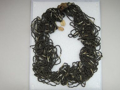 Hupa. <em>Necklace</em>. Juniper berries, dentalium shells, glass beads, cotton string,  cotton cloth, 11 3/4 × 1 × 14 1/4 in. (29.8 × 2.5 × 36.2 cm). Brooklyn Museum, Museum Expedition 1905, Museum Collection Fund, 05.588.7501. Creative Commons-BY (Photo: Brooklyn Museum, CUR.05.588.7501.jpg)