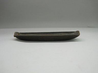 George Capelle (Yurok). <em>Toy Canoe</em>. Wood, fiber, 2 1/8 × 1 3/8 × 9 1/16 in. (5.4 × 3.5 × 23 cm). Brooklyn Museum, Museum Expedition 1905, Museum Collection Fund, 05.588.7567. Creative Commons-BY (Photo: Brooklyn Museum, CUR.05.588.7567.jpg)