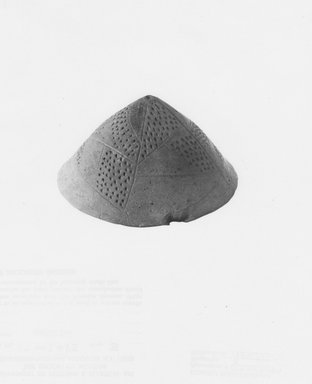  <em>Conical Lid</em>, ca. 3300-3100 B.C.E. Clay, height: 2 1/8 in. (5.4 cm); greatest diam.: 4 1/8 in. (10.5 cm) . Brooklyn Museum, Charles Edwin Wilbour Fund, 07.447.485. Creative Commons-BY (Photo: Brooklyn Museum, CUR.07.447.485_NegB_print_bw.jpg)