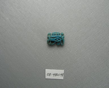  <em>Wadjet-eye Amulet</em>. Faience, 7/16 x 3/16 x 5/8 in. (1.1 x 0.5 x 1.6 cm). Brooklyn Museum, Charles Edwin Wilbour Fund, 08.480.144. Creative Commons-BY (Photo: Brooklyn Museum, CUR.08.480.144_view1.jpg)