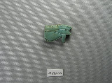  <em>Wadjet-eye Amulet</em>. Faience, 13/16 x 1/4 x 1 3/16 in. (2 x 0.7 x 3 cm). Brooklyn Museum, Charles Edwin Wilbour Fund, 08.480.145. Creative Commons-BY (Photo: Brooklyn Museum, CUR.08.480.145_view1.jpg)