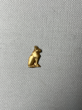  <em>Seated Cat Amulet</em>, 664-30 B.C.E. Sheet gold, 3/4 x 7/16 in. (1.9 x 1.2 cm). Brooklyn Museum, Charles Edwin Wilbour Fund, 08.480.211. Creative Commons-BY (Photo: Brooklyn Museum, CUR.08.480.211_overall.JPG)