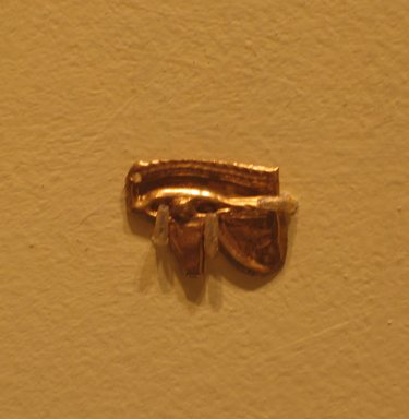  <em>Wadjet-eye Amulet</em>, 664–343 B.C.E. Gold, 7/16 x 5/8 x 1/16 in. (1.2 x 1.6 x 0.1 cm). Brooklyn Museum, Charles Edwin Wilbour Fund, 08.480.216. Creative Commons-BY (Photo: Brooklyn Museum, CUR.08.480.216_pqg.jpg)