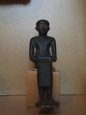  <em>Seated Statuette of Imhotep</em>, ca. 664-30 B.C.E. Bronze, gold, 5 3/16 x 1 9/16 in. (13.2 x 3.9 cm). Brooklyn Museum, Charles Edwin Wilbour Fund, 08.480.24. Creative Commons-BY (Photo: Brooklyn Museum, CUR.08.480.24_temples.jpg)