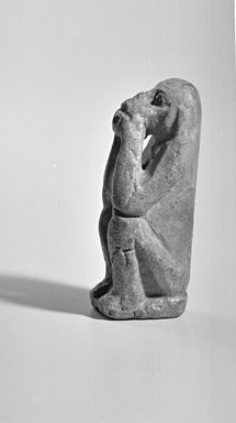  <em>Figurine of a Seated Monkey</em>, 1550-1070 B.C.E. or 664-525 B.C.E. Faience, 3 1/16 x 1 1/4 in. (7.8 x 3.2 cm). Brooklyn Museum, Charles Edwin Wilbour Fund, 08.480.74. Creative Commons-BY (Photo: Brooklyn Museum, CUR.08.480.74_NegG_bw.jpg)