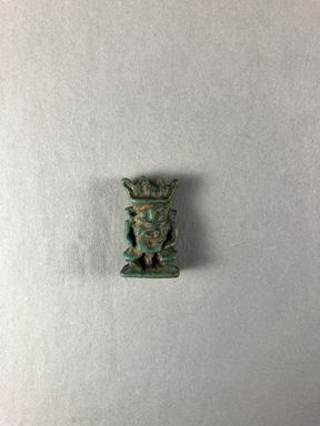 Egyptian. <em>Bes as Amulet</em>, ca. 1075-656 B.C.E. Faience, 1 × 9/16 × 5/16 in. (2.5 × 1.5 × 0.8 cm). Brooklyn Museum, Charles Edwin Wilbour Fund, 08.480.98. Creative Commons-BY (Photo: , CUR.08.480.98_view01.jpg)