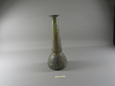 Roman. <em>Bottle</em>, 1st-5th century C.E. Glass, 8 9/16 x Diam. 3 5/16 in. (21.7 x 8.4 cm). Brooklyn Museum, Gift of Robert B. Woodward, 09.52. Creative Commons-BY (Photo: Brooklyn Museum, CUR.09.52_view1.jpg)