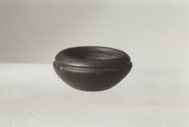  <em>Miniature Bowl for Mixing Make-up</em>, ca. 1938-1700 B.C.E. Slate, 11/16 x Greatest Diam. 1 9/16 in. (1.8 x 3.9 cm). Brooklyn Museum, Charles Edwin Wilbour Fund, 09.889.16. Creative Commons-BY (Photo: Brooklyn Museum, CUR.09.889.16_NegL1011_25_print_bw.jpg)