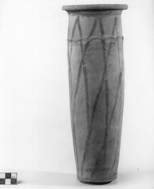  <em>Painted Cylindrical Vase with Wavy Handled Motif</em>, ca. 4400-3100 B.C.E. Terracotta, pigment, 11 7/8 x 1 9/16 in. (30.2 x 4 cm). Brooklyn Museum, Charles Edwin Wilbour Fund, 09.889.694. Creative Commons-BY (Photo: Brooklyn Museum, CUR.09.889.694_NegA_print_bw.jpg)