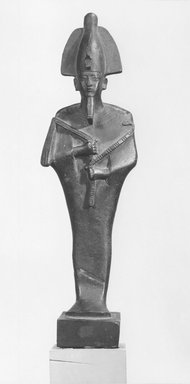  <em>Standing Mummiform Figure of Osiris</em>, 664-332 B.C.E. Bronze, 10 9/16 x 2 15/16 x 1 15/16 in. (26.8 x 7.5 x 5 cm). Brooklyn Museum, Museum Collection Fund, 11.664. Creative Commons-BY (Photo: Brooklyn Museum, CUR.11.664_NegA_print_bw.jpg)