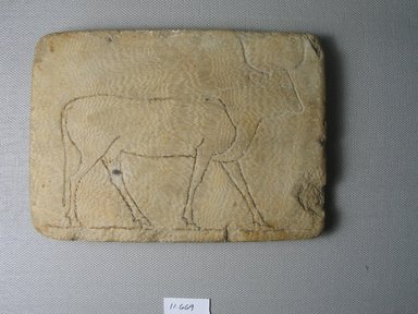  <em>Oblong Plaque with Figure of a Cow</em>. Egyptian alabaster (calcite), 4 1/4 x 6 7/16 x 9/16 in. (10.8 x 16.3 x 1.5 cm). Brooklyn Museum, Museum Collection Fund, 11.669. Creative Commons-BY (Photo: Brooklyn Museum, CUR.11.669_front.jpg)