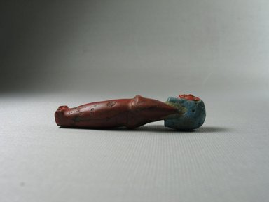  <em>Red and Blue Standing Mummiform Figure</em>. Glass, 2 7/8 × 3/4 in. (7.3 × 1.9 cm). Brooklyn Museum, Museum Collection Fund, 11.683. Creative Commons-BY (Photo: Brooklyn Museum, CUR.11.683_view3.jpg)