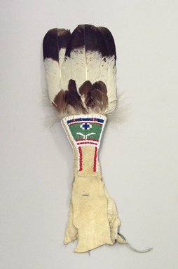 Osage. <em>Fan (iki thadsin)</em>, late 19th–early 20th century. Winter hawk feather, glass beads, wood, wool, hide, pigment, 1 x 7 x 23 1/2 in. (2.5 x 17.8 x 59.7 cm). Brooklyn Museum, Museum Expedition 1911, Museum Collection Fund, 11.694.8977. Creative Commons-BY (Photo: Brooklyn Museum, CUR.11.694.8977_view1.jpg)