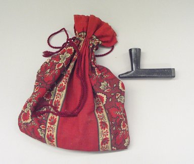 Osage. <em>Pipe with Bag</em>, late 19th-early 20th century. Black stone, cloth,unknown contents, 7 x 2 x 13.5 in.  (17.8 x 5.1 x 34.3 cm). Brooklyn Museum, Museum Expedition 1911, Museum Collection Fund, 11.694.9039. Creative Commons-BY (Photo: Brooklyn Museum, CUR.11.694.9039.jpg)